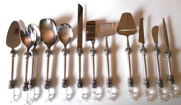 Cake lifter, salad servers, rice server, server, bread knife, cheese hatched, cheese grater, cheese planer, cheese knifw, butter or pate spreader, letter opener. Style - Ornate Jewel